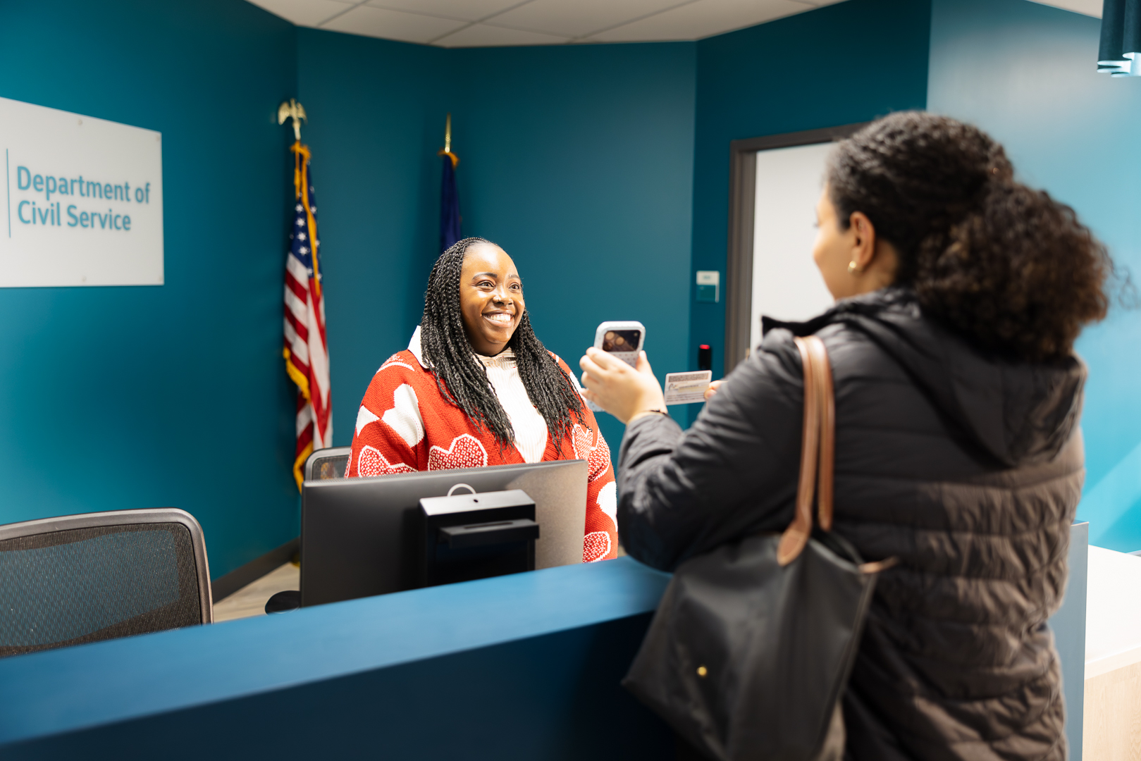woman greeting test taker at the front desk